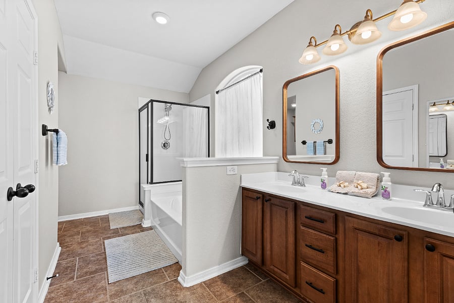 Large master bathroom has shower, soaking tub, and walk in closet with custom shelving.