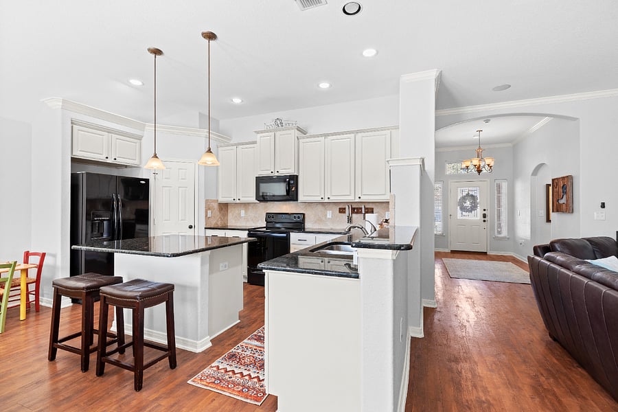 The kitchen is bright and open, with high ceilings.