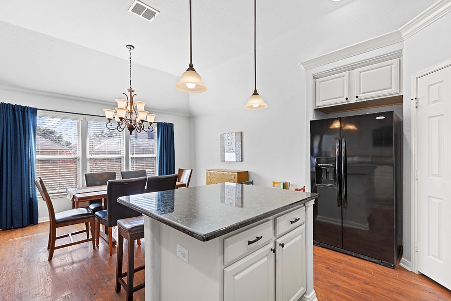 Kitchen is bright and open, with granite countertops and island that seats two. Kitchen is fully stocked. Stainless steel dishwasher with third rack.