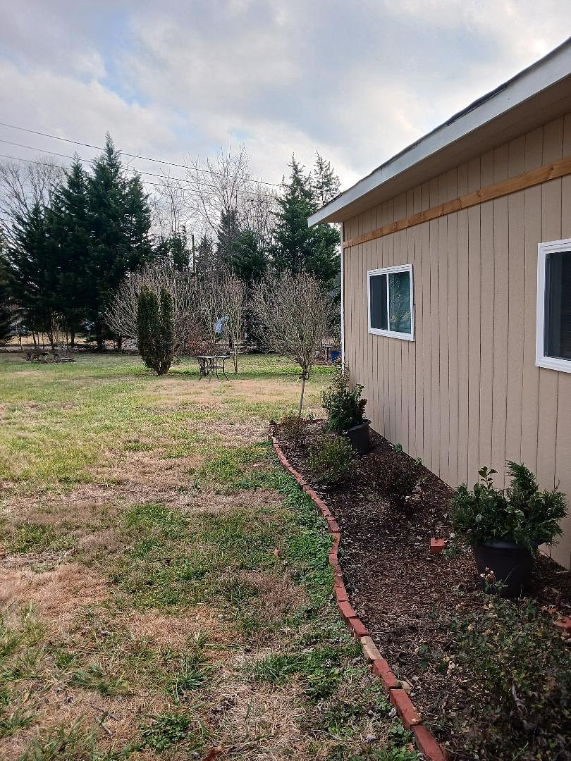 Spacious yard filled with birds and flowering shrubs 