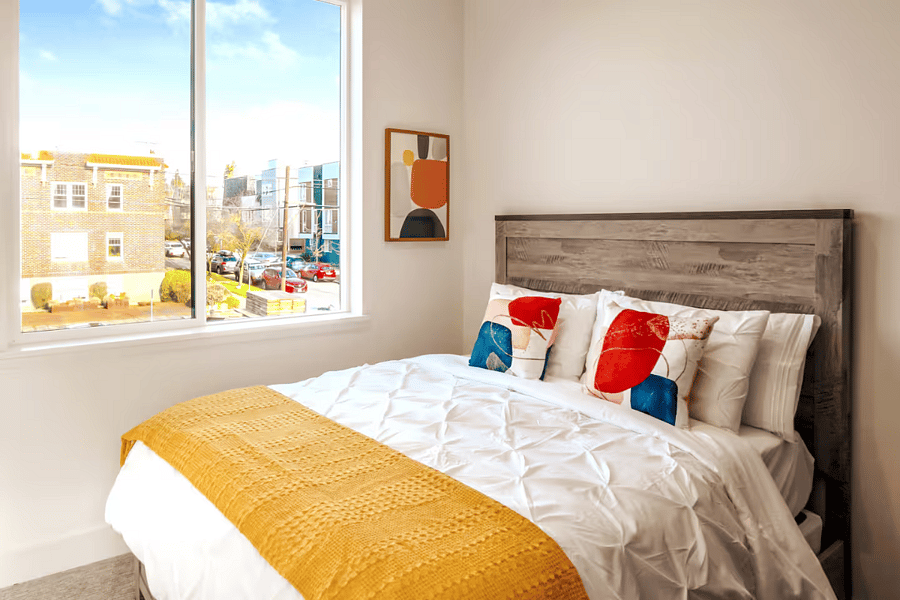 The first queen bedroom on level 2. Hotel style bedding and extra blanket provided with every bed. Extra pillows in the bedroom closet