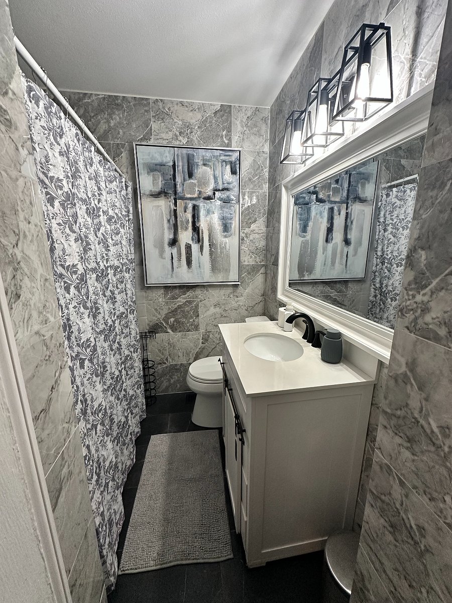 hall bathroom has a tub and gorgeous tiled walls