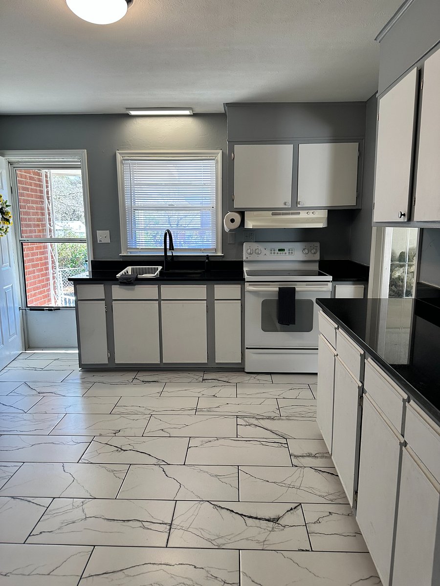 tile floor, granite countertops, plenty of cabinet space. Door to the driveway and then to backyard.