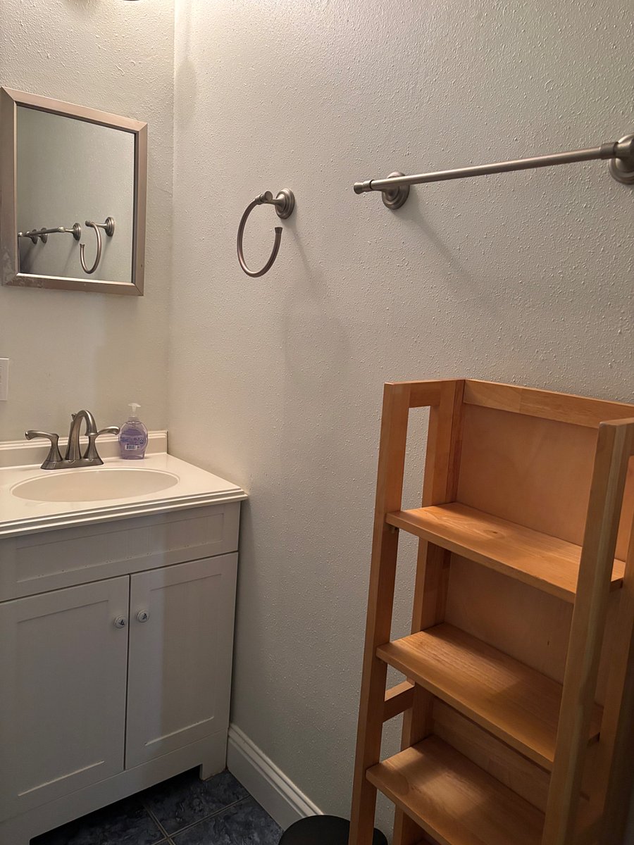 Shelves for bathroom supplies and a linen closet.