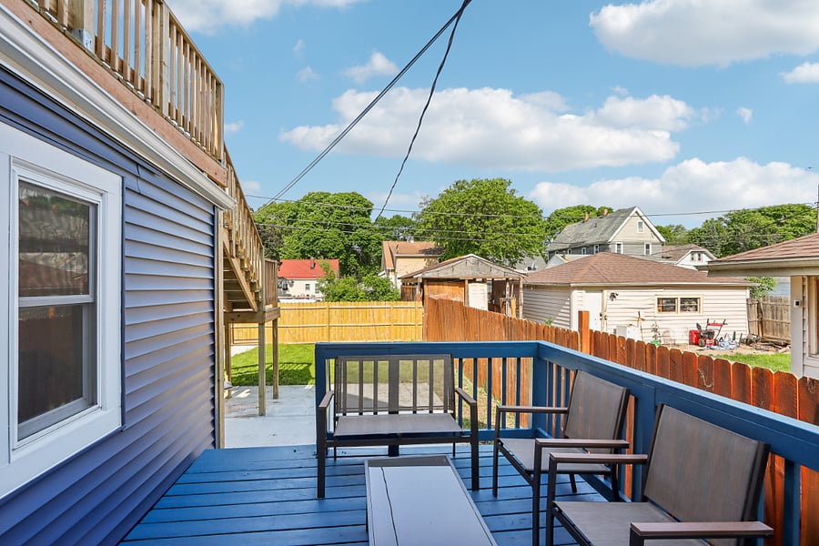 Private back porch overlooking partially fenced yard