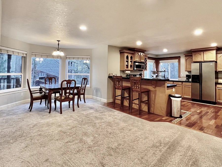 Unit includes full kitchen and dining area with table that seats six (four matching dining room chairs included, can bring chairs from other areas,) with forest view. Bar-height counter with two bar-height chairs for chatting while cooking.