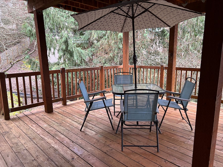 Private deck accessible from dining area, with forest view. Has stairs down to yard for pet needs.