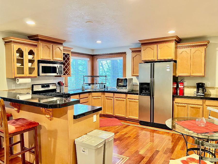 Kitchen includes full size refrigerator, natural gas stove, microwave, and counter dishwasher (can wash 4 full place settings at once.) Coffee maker, toaster, and small air fryer in cabinets. Full service for six dishes included, as well as cooking essentials. (Pots, pans, knives, stir/serving utensils, etc.)