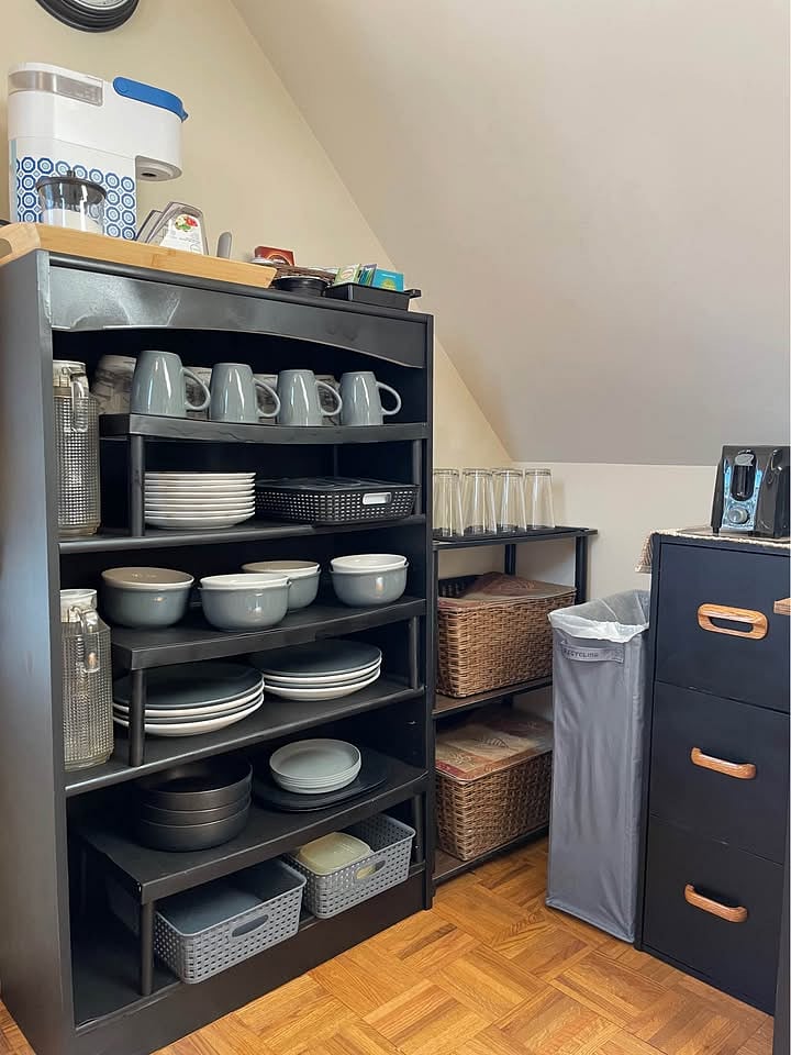 Keurig coffee station on top, with cups, dishes, glasses, flatware, etc. below. Yes, wine glasses too, you just can't see them in this photo!