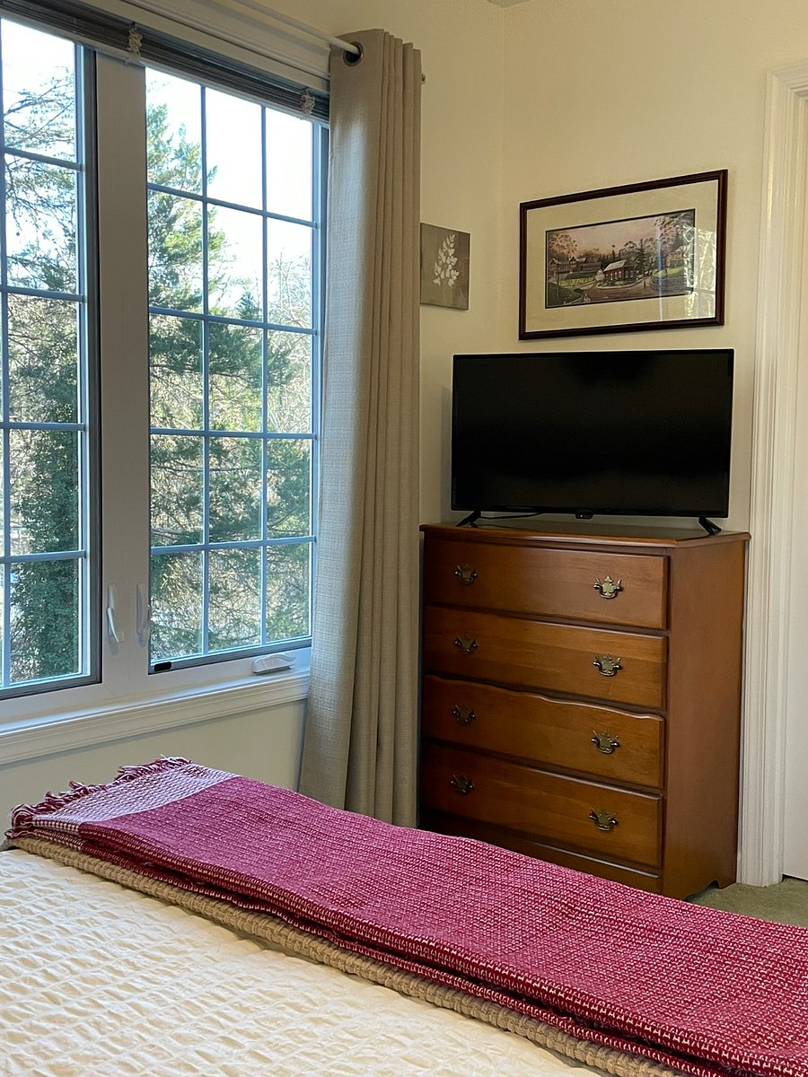 Watch TV from bed, or swing the green chair around to face the TV.