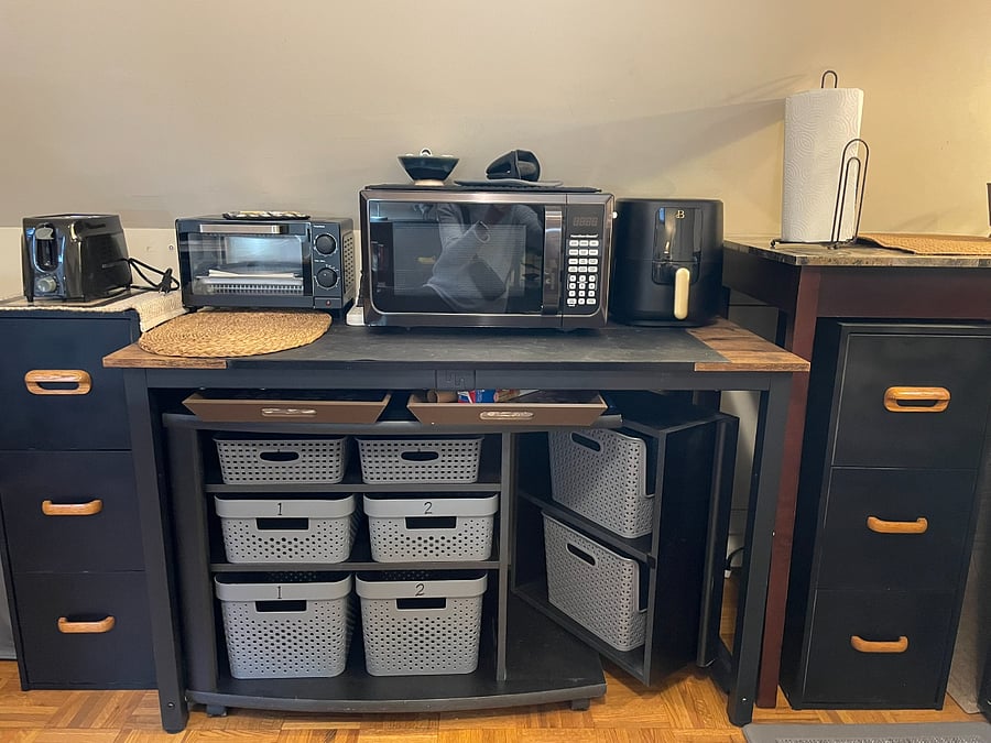 Toaster, toaster oven, microwave, and air fryer.  Storage drawers and bins below for your grocery items and miscellaneous cooking tools and supplies.  Trays in case you want to eat in your bedroom.