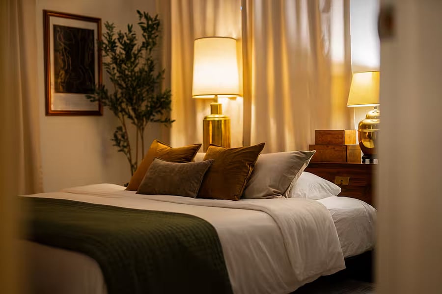 The thoughtfully curated primary bedroom is inviting, swoon worthy, and perfect for comfortably watching movies on the 55" TV or sleeping in with room darkening curtains.