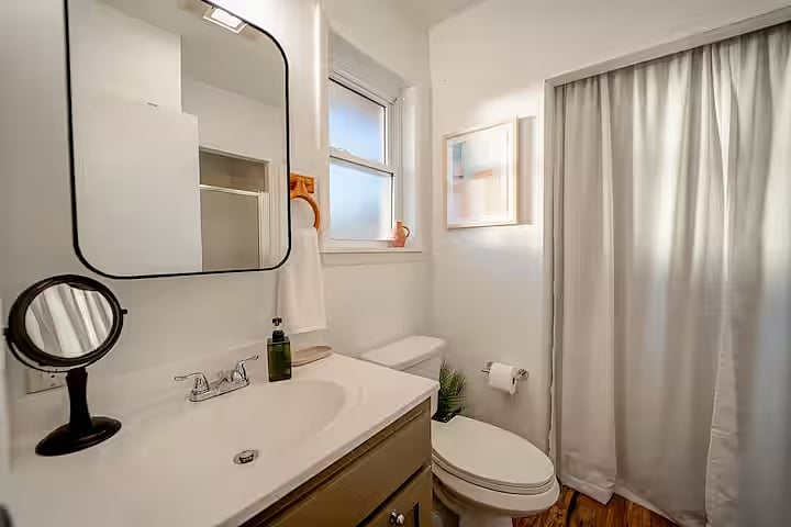 Medicine cabinet with mirror and storage.