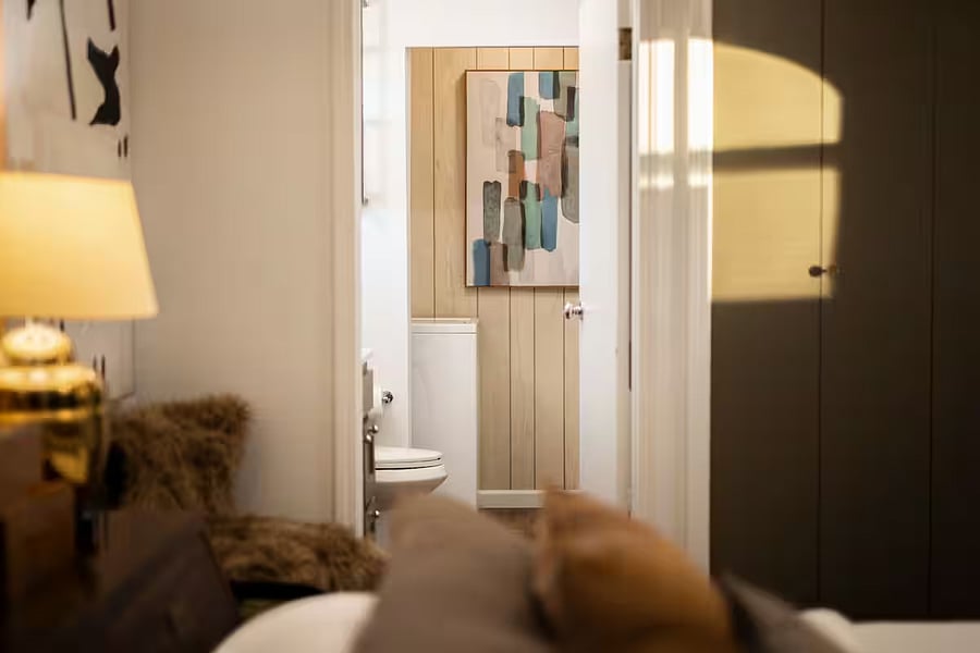 Primary bedroom and en suite bathroom with walk-in shower and full-size washer and dryer.