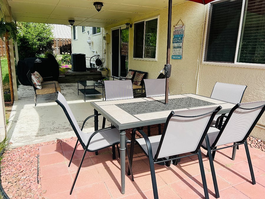 Peaceful backyard patio and seating area available for guests to enjoy fresh air.