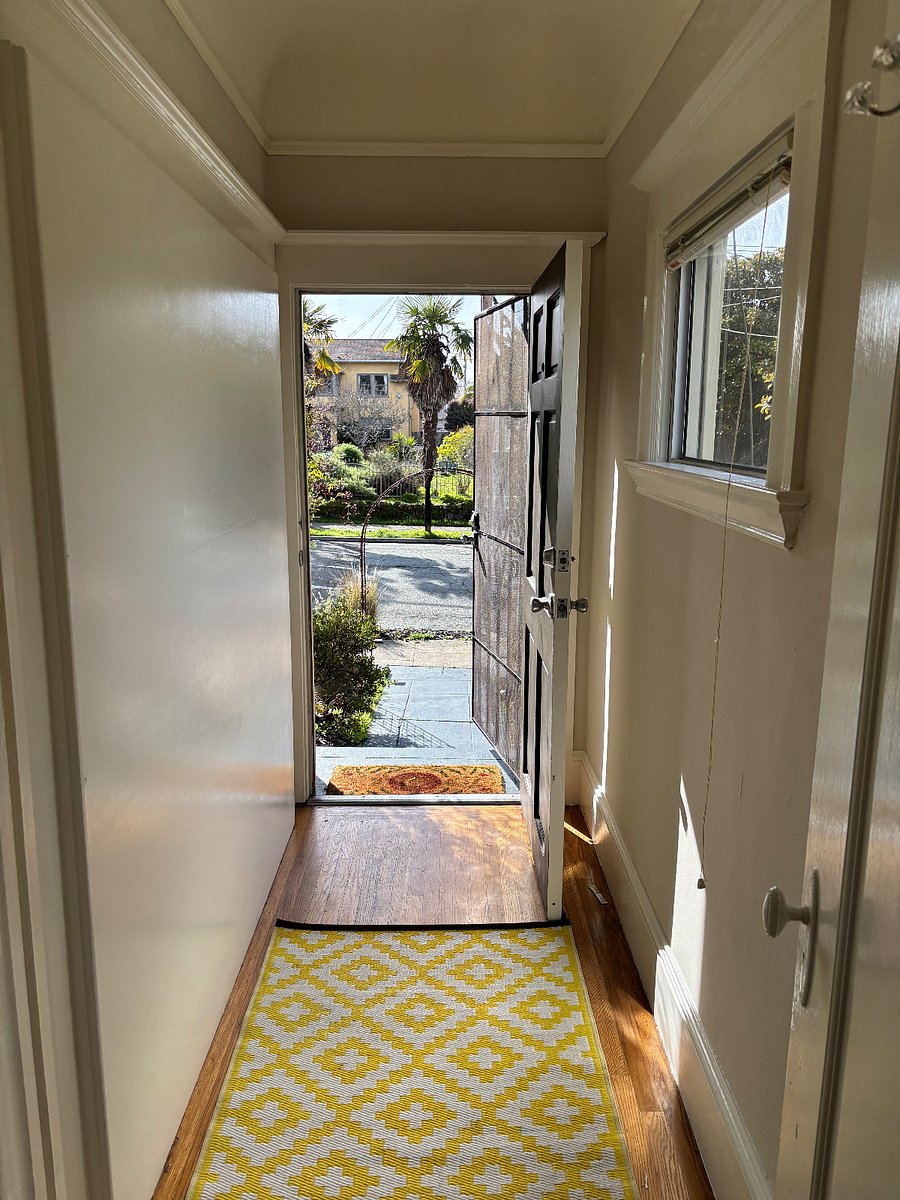 Entrance hallway, walk up has 4 stairs. There is a security door as well as a wood front door.