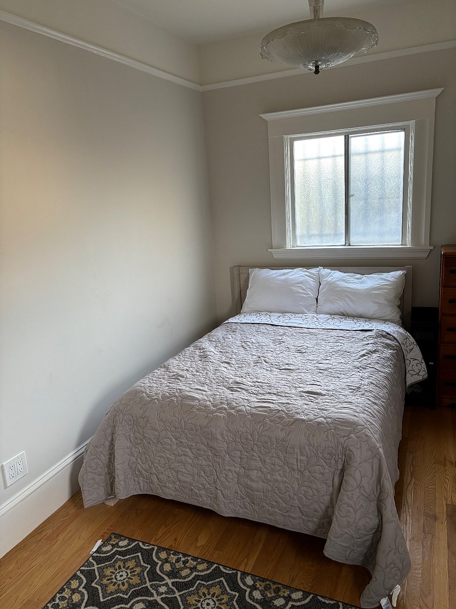 Bedroom with Full bed in the rear room of unit next to bathroom.