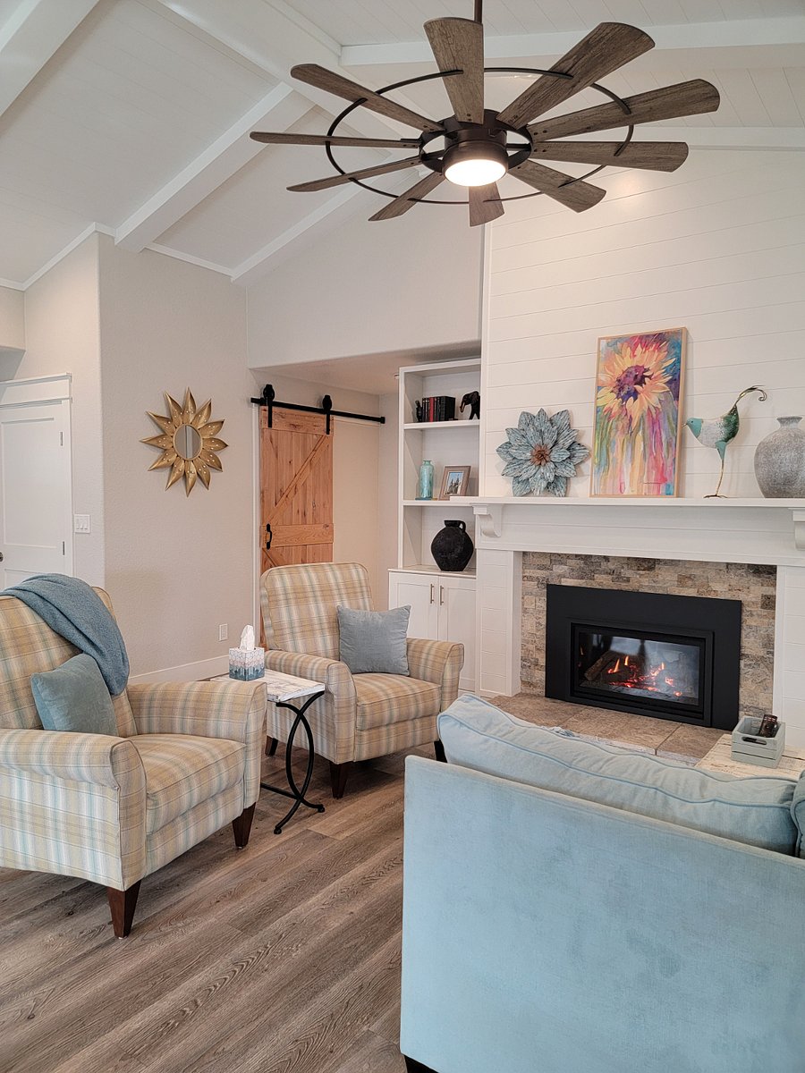 Living room has L shaped sofa, 2 recliner chairs, gas fireplace and 60 smart tv