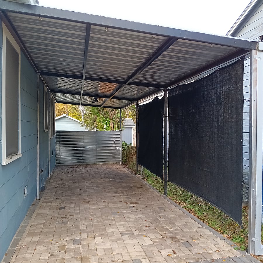 Carport has screen to protect from the sun and has space for 2 cars