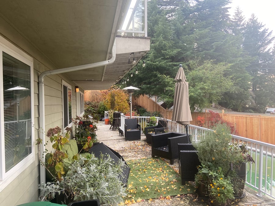 back lower deck to access gas bbq, pool for the summer and a small view of lake washington located across the stree from home with bluff to waterfront.