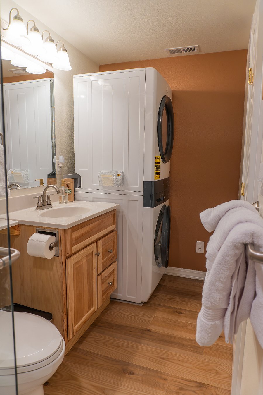 View of bathroom from the shower. Full capacity washer and dryer to make laundry fast and simple.