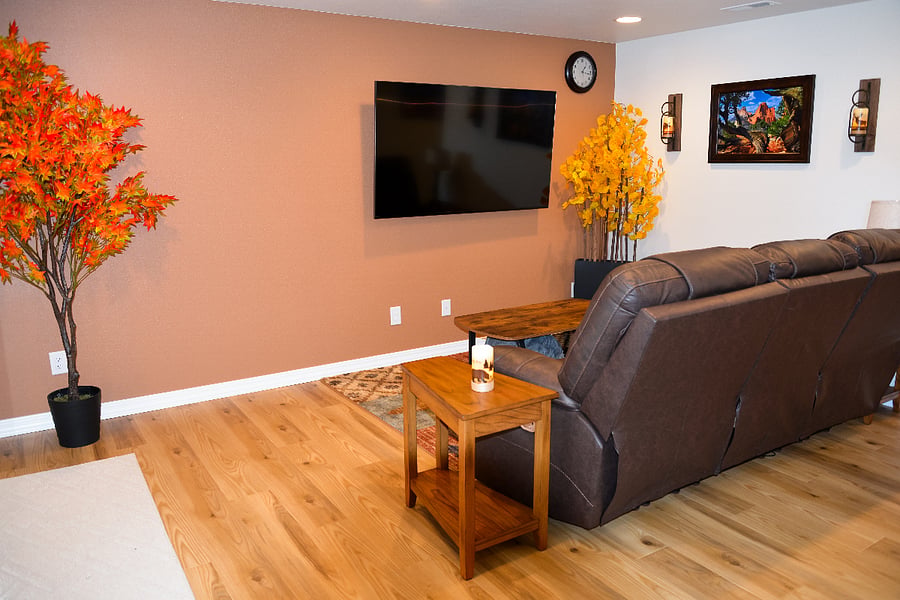 Living room with a Smart TV that is ready for you to login and access your streaming services. Both ends of the couch recline with individual controls for head, back, and feet.