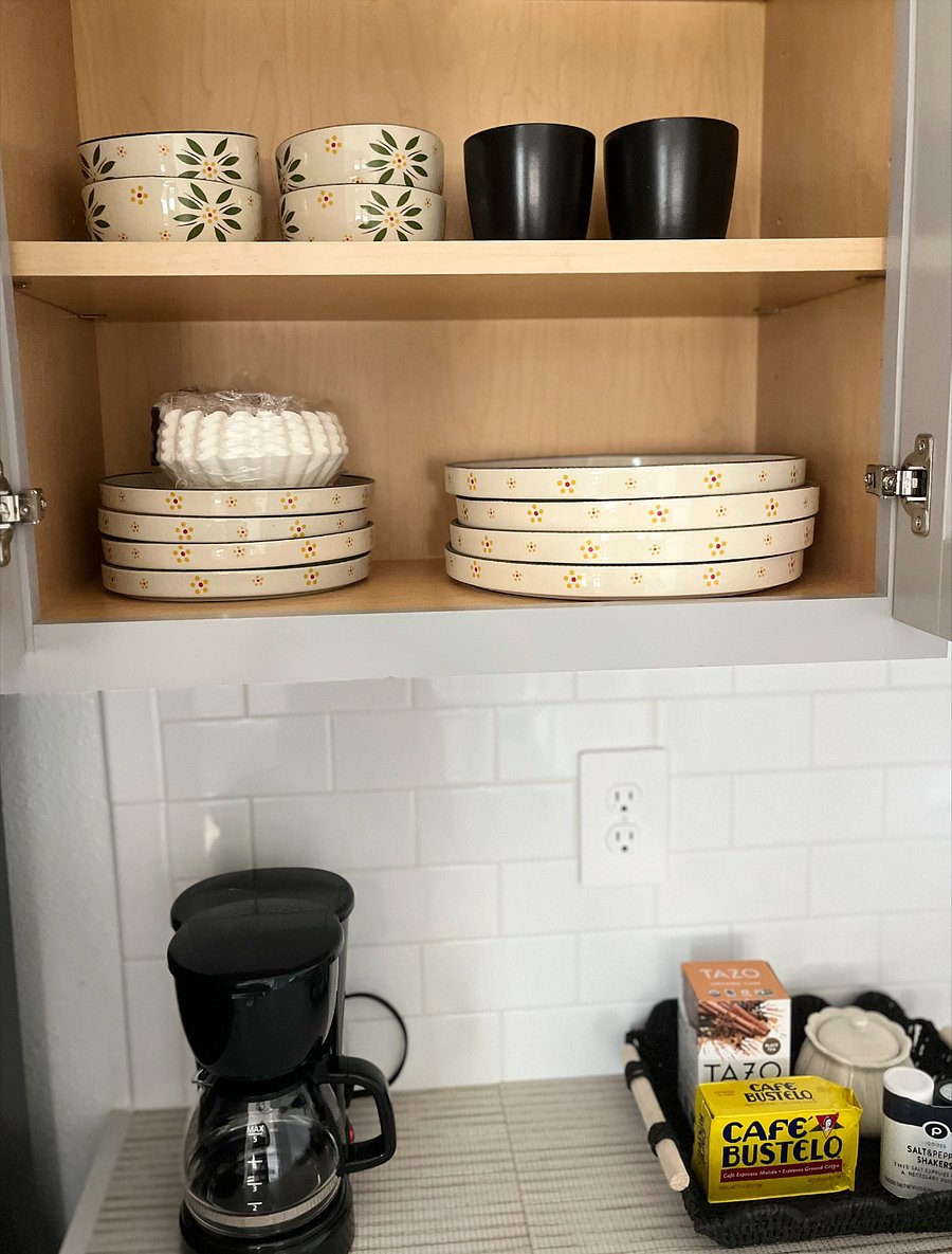 Fully equipped kitchen with plates, silverware, and cookware. Please note: The kitchen does not have a traditional stove, but is equipped with two convenient hotplates for cooking. Also includes coffee maker, dishwasher, full-size refrigerator, and microwave