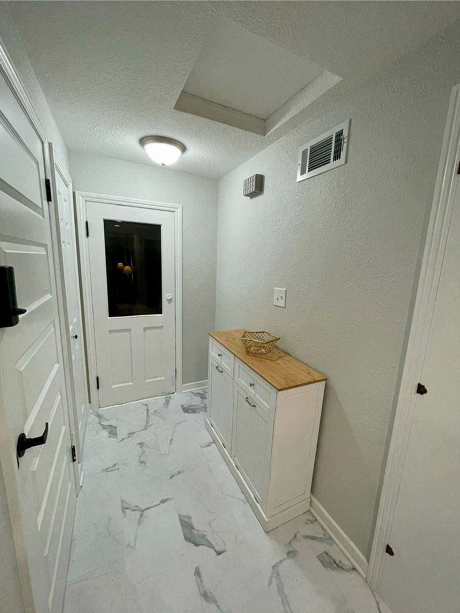 Entryway. 
Garbage cans located inside cabinet