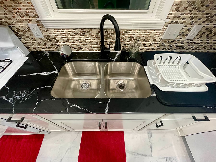 Dish dry rack stored under the sink, if you prefer to not use the dishwasher. Sink with garbage disposal.