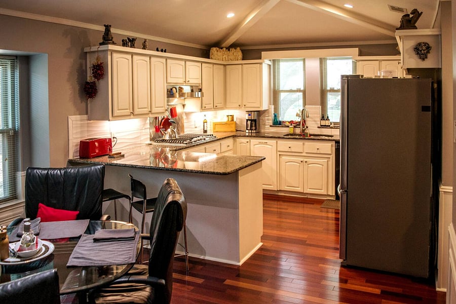 View of the gourmet kitchen that is stocked with appliances, dishes, cookware, a gas range, double ovens & spices to help you prepare any meal of the day. The Breakfast nook with window seat is also great for reading.