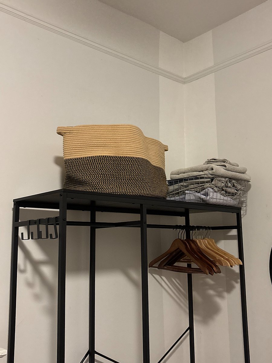 Laundry basket, extra sheets and blankets. 
