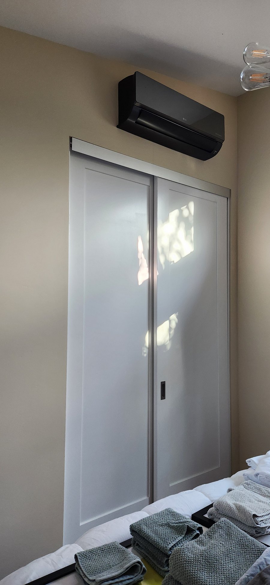 Big, tall closet. The box above it is an A/C and heater wall unit dedicated to the bedroom.