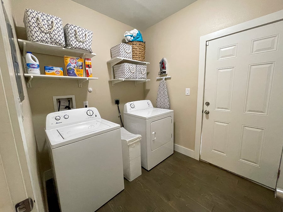 Laundry room featuring open shelving. Storage closet found on the back wall.