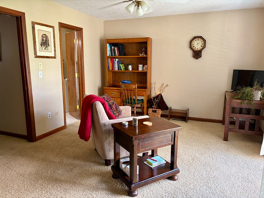 Master suite sitting area with desk, bookcase and TV
