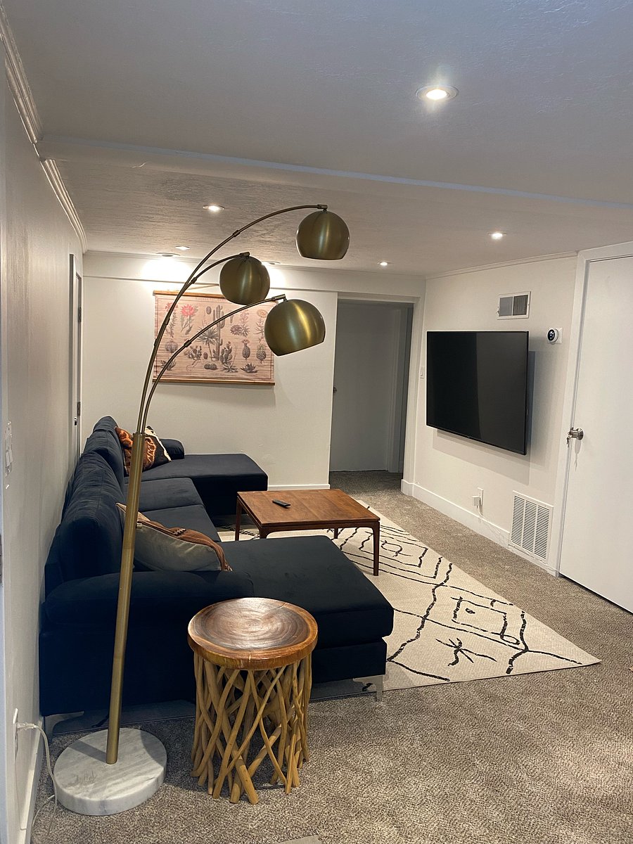 Living room with cozy sectional couch, dimmable lighting and smart TV