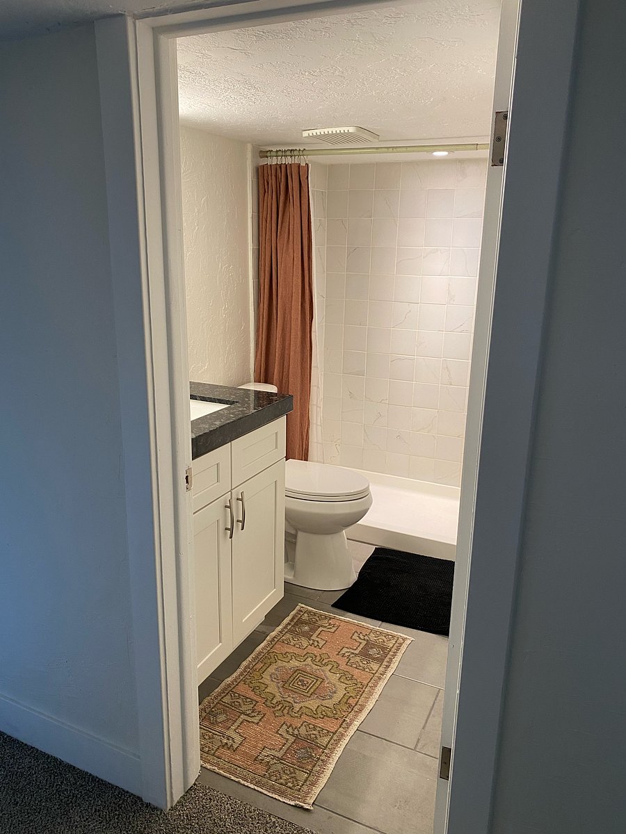 Bathroom with stand up shower. The home has a tankless water heater so there will ALWAYS be hot water available and the pressure remains the same as well.