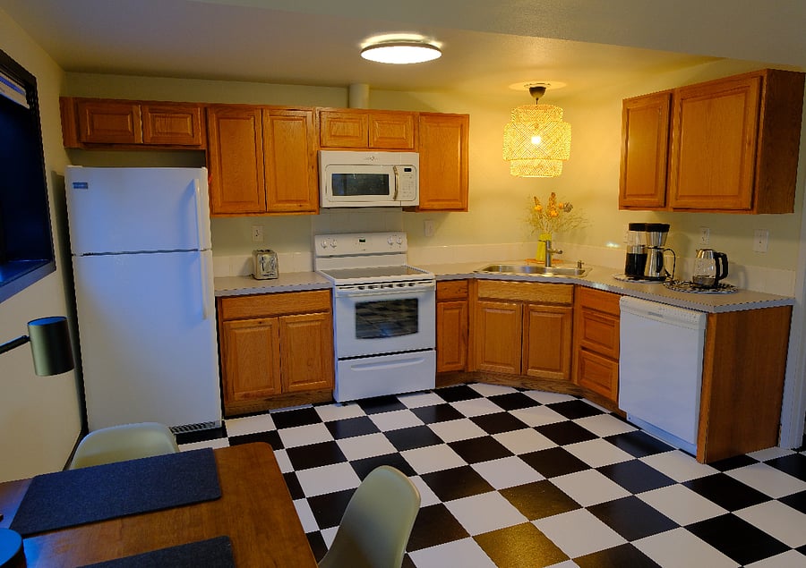 Kitchen with full-size fridge, microwave, range, sink, and dishwasher