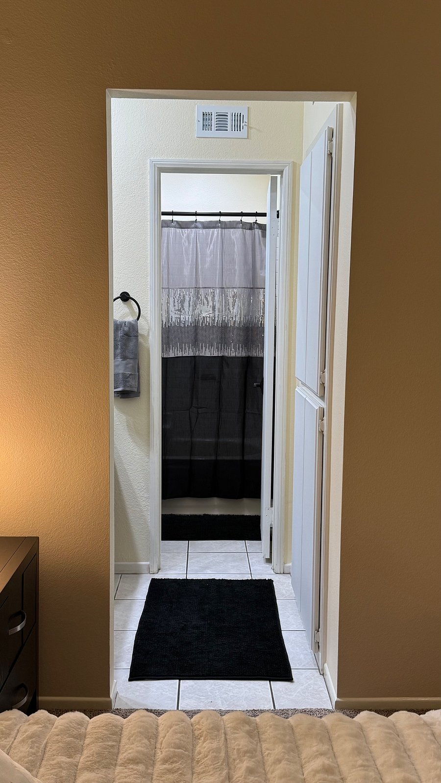 Large cabinet storage is located directly across from the vanity. Cleaning supplies as well as kitchen dishes and utensils are located in these cabinets.