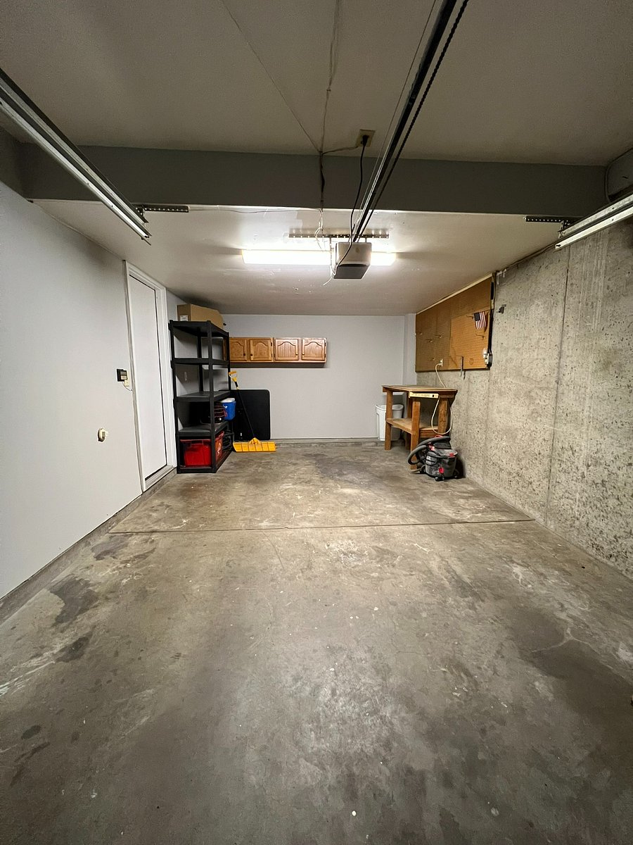 One Car Garage with Storage Shelves and Work Bench