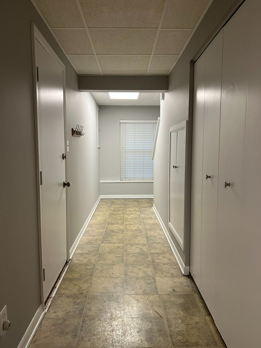 Lower Lover Hallway (Door to Garage on Left, Storage and Washer/Dryer Doors on Left)