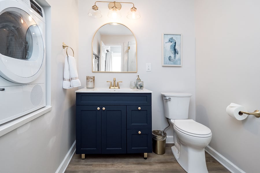 This bathroom is beautiful with brushed gold accents and lovely vanity area.