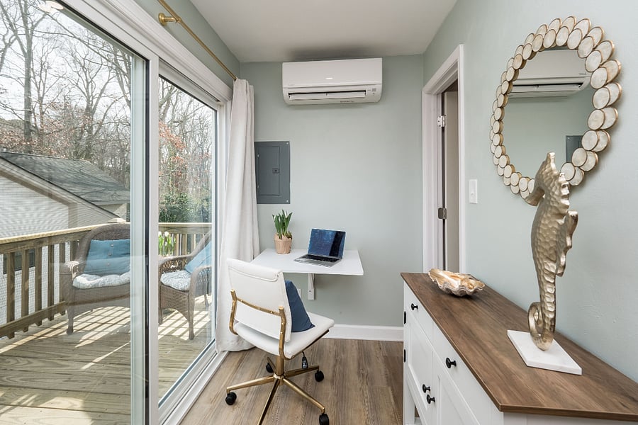 The work station is by the large glass entrance so natural light flows in.  The small deck is yours to enjoy with a seating area perfect for a coffee break.