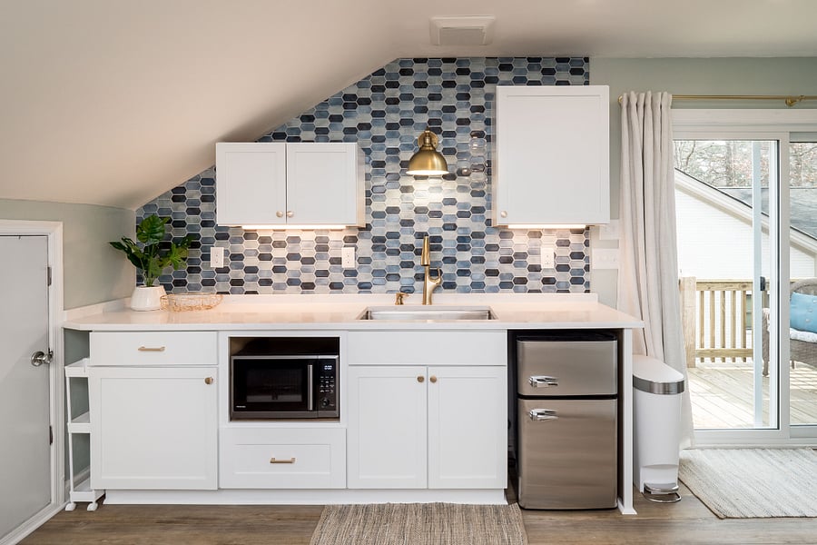 This charming kitchenette has multi-purpose appliances that make it easy to cook from home.