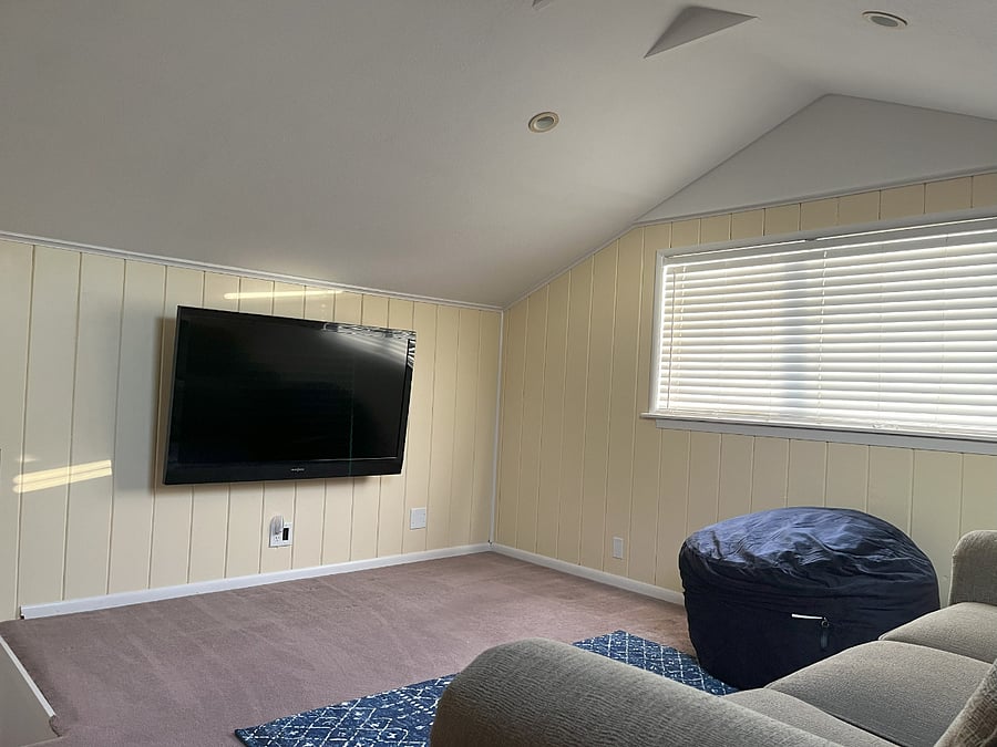 Upstairs bonus room with smart tv and reclining couch