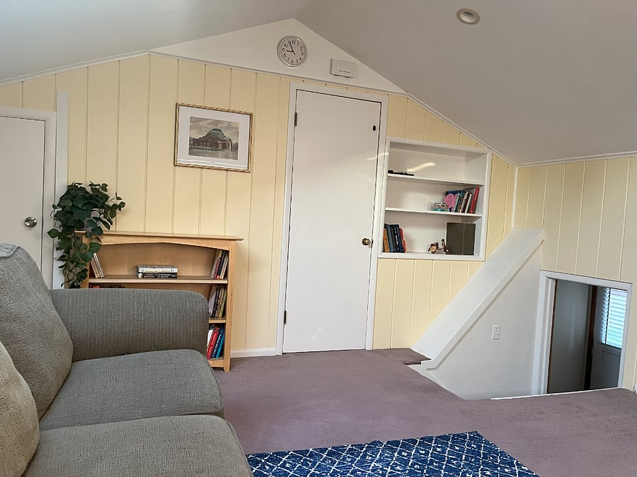 Upstairs bonus room with smart tv and reclining couch