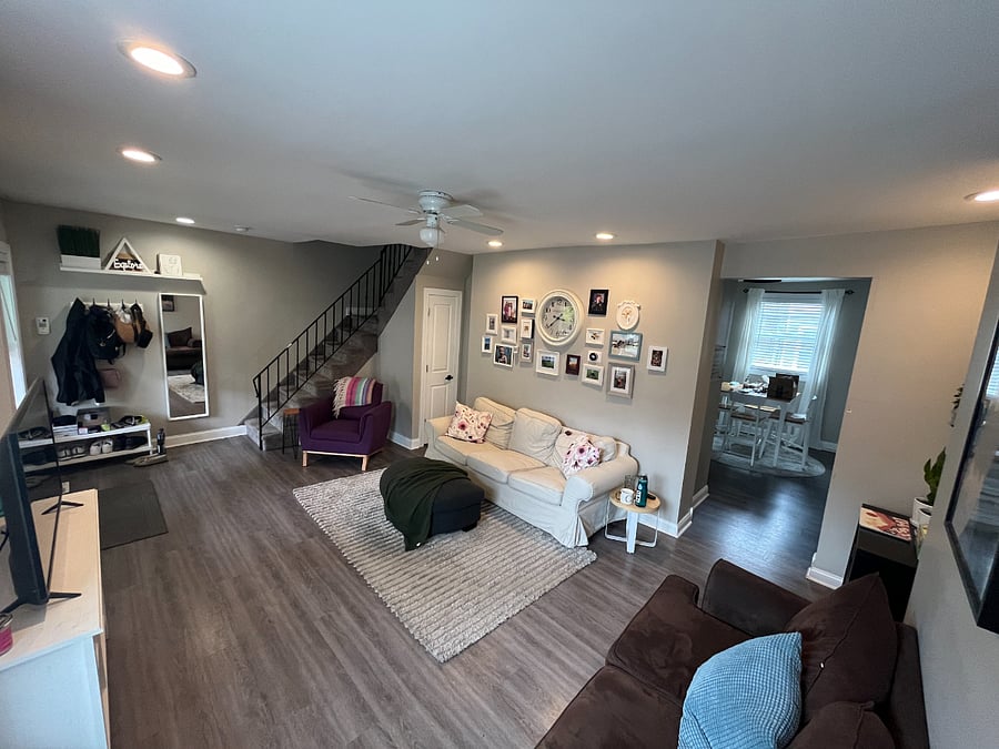 Living room with coat closet and Nest thermostat. 