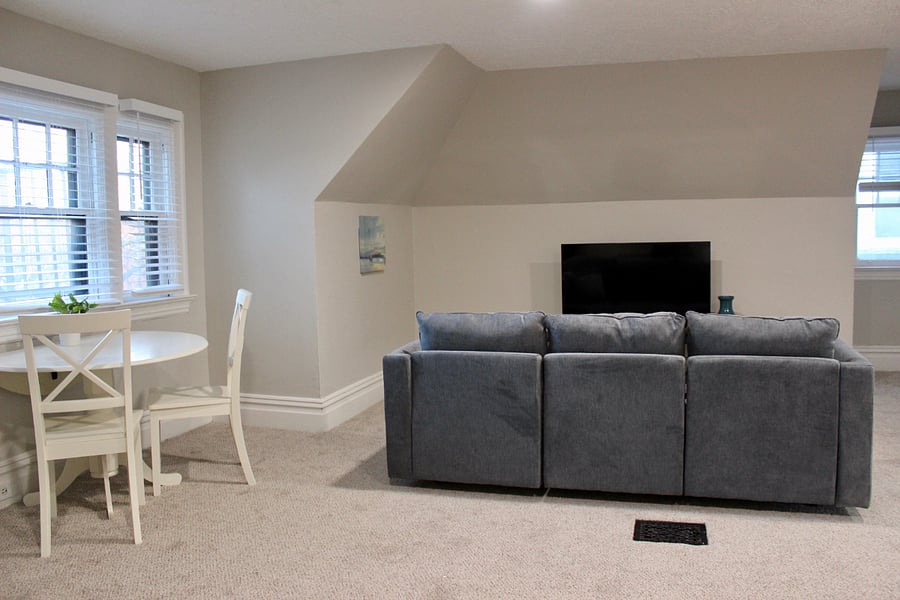 The living area features a 50" Roku TV, also visible from the dining room and kitchen