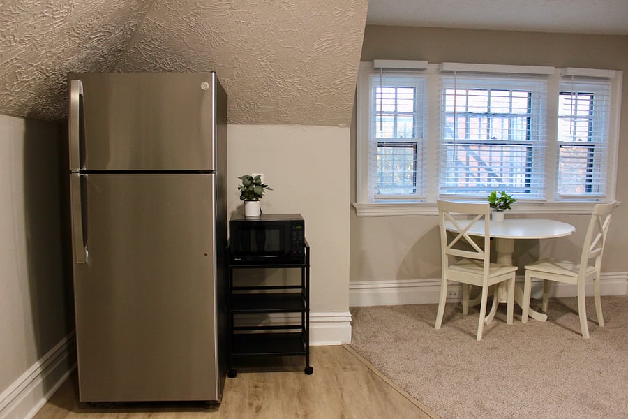 Stainless steel refrigerator and microwave set on a convenient kitchen cart