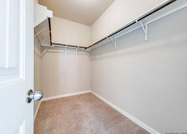 Master bedroom closet, with bench and luggage racks