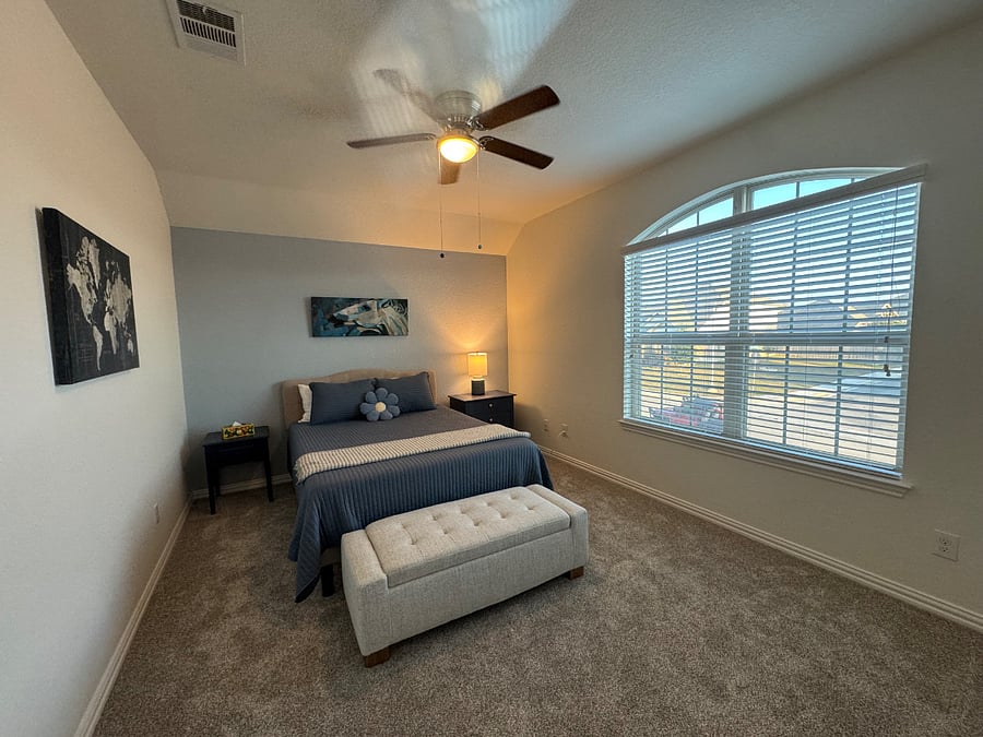 Spacious and bright upstairs guest room with queen bed